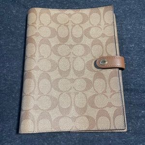 Coach signature monogram notebook cover.